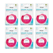 Six pink dental floss containers arranged in two rows against white packaging displaying product information.