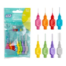 Colorful interdental brushes and cleaning tools displayed in packaging for dental hygiene care.