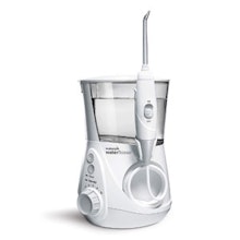 Waterpik oral irrigator with water reservoir and pressure settings on white background.