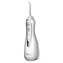 Cordless water flosser device in white with ergonomic handle and jet tip nozzle.