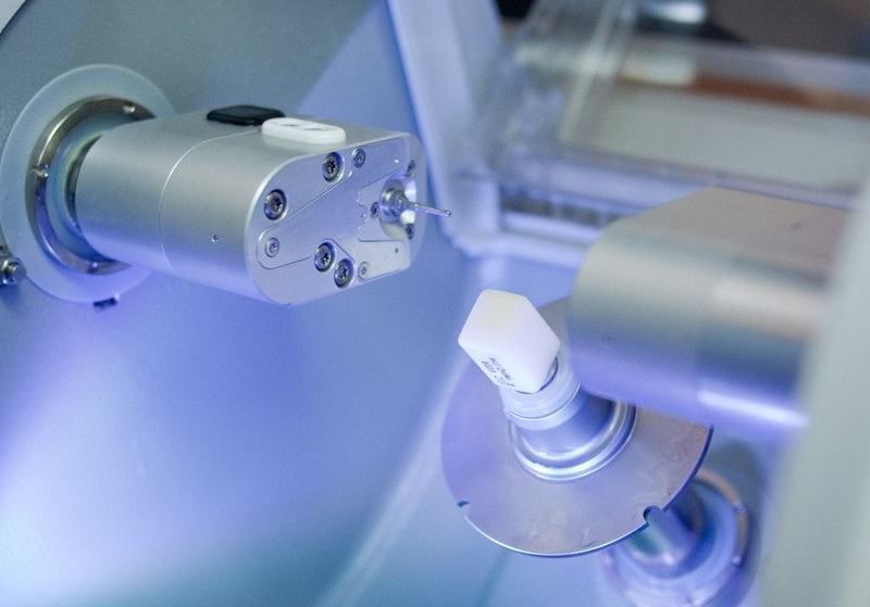 Dental laboratory equipment with precision tools and blue lighting in clinical setting.
