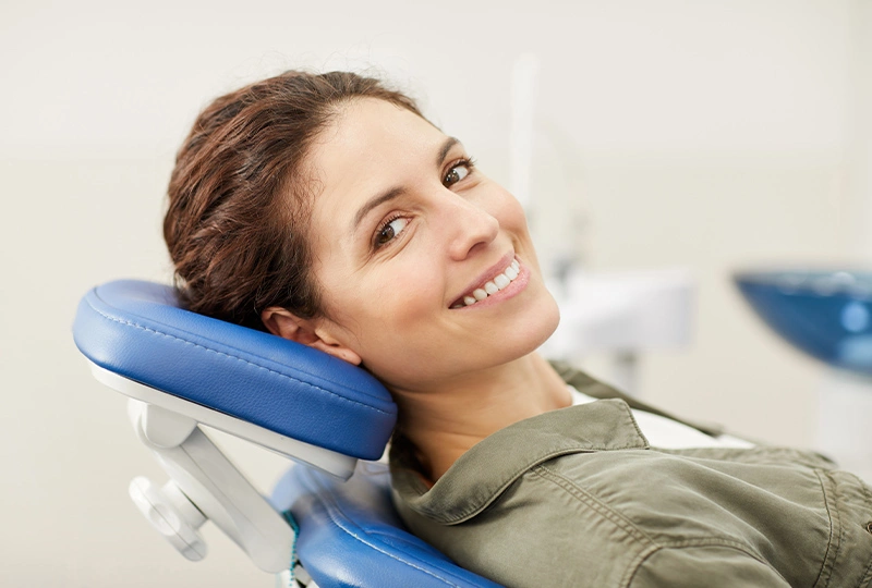 Woman smiling in dental chair at Jersey City dental office during examination.